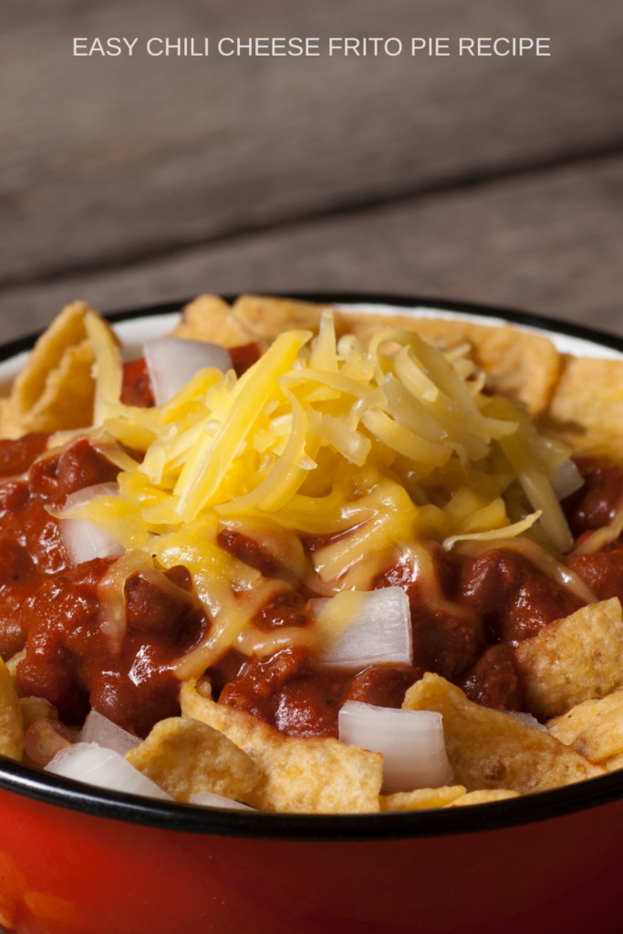 Frito Pie topped with cheese and onions.
