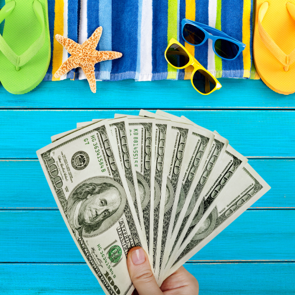 How Can I Be Frugal In The Summer?: Hand holding cash with summer accessories in the background with text: How can I be frugal in the summer